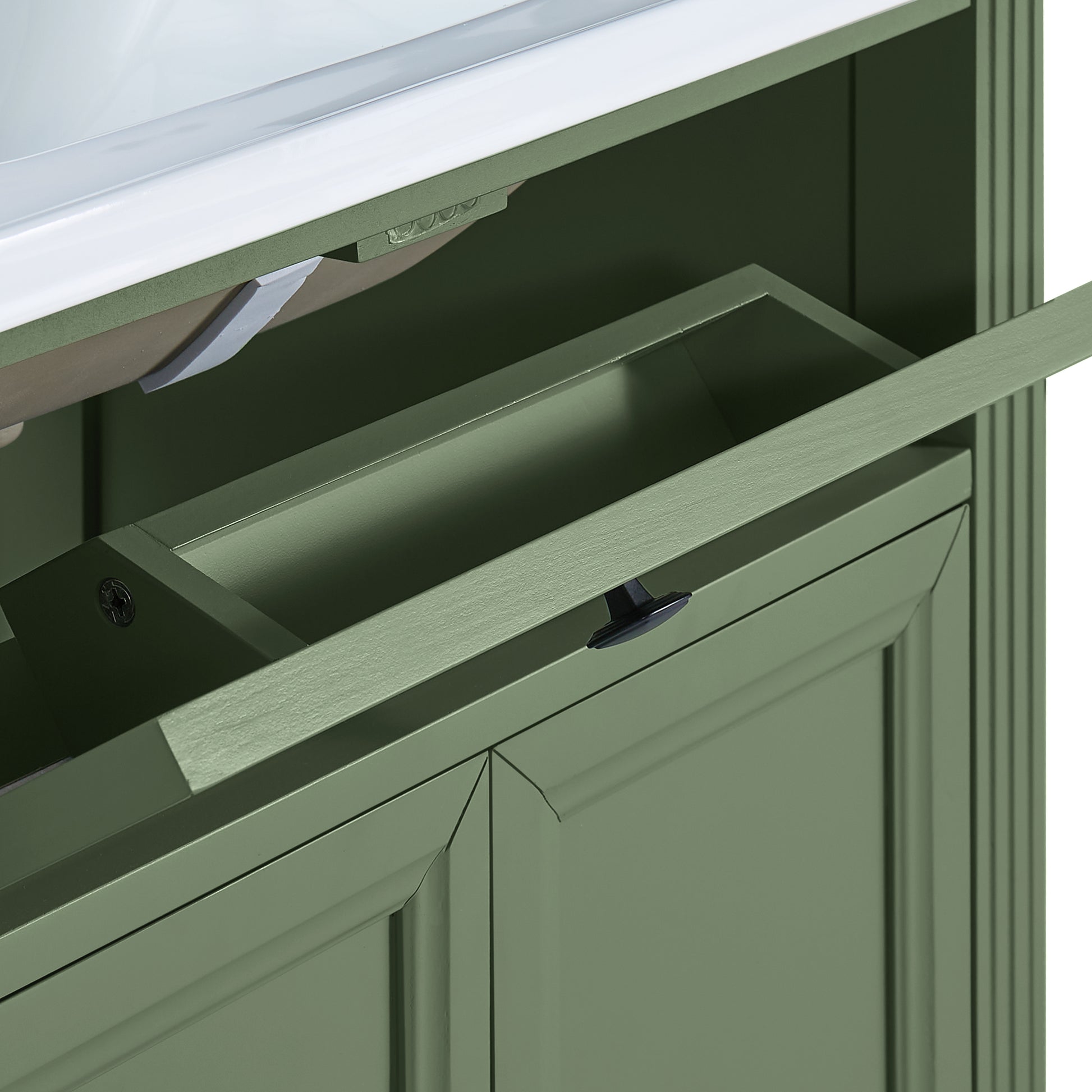 Close-up of a Olive green bathroom vanity cabinet with a pull-out storage drawer and a countertop edge visible.