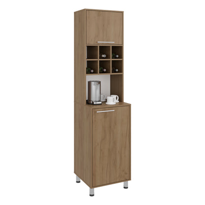 A tall, narrow wooden bar or beverage cabinet with a top door, open shelving, a lower drawer, and small silver legs. The cabinet is shown empty against a plain white background, with a coffee maker and mugs placed on the countertop as styling props. Natural