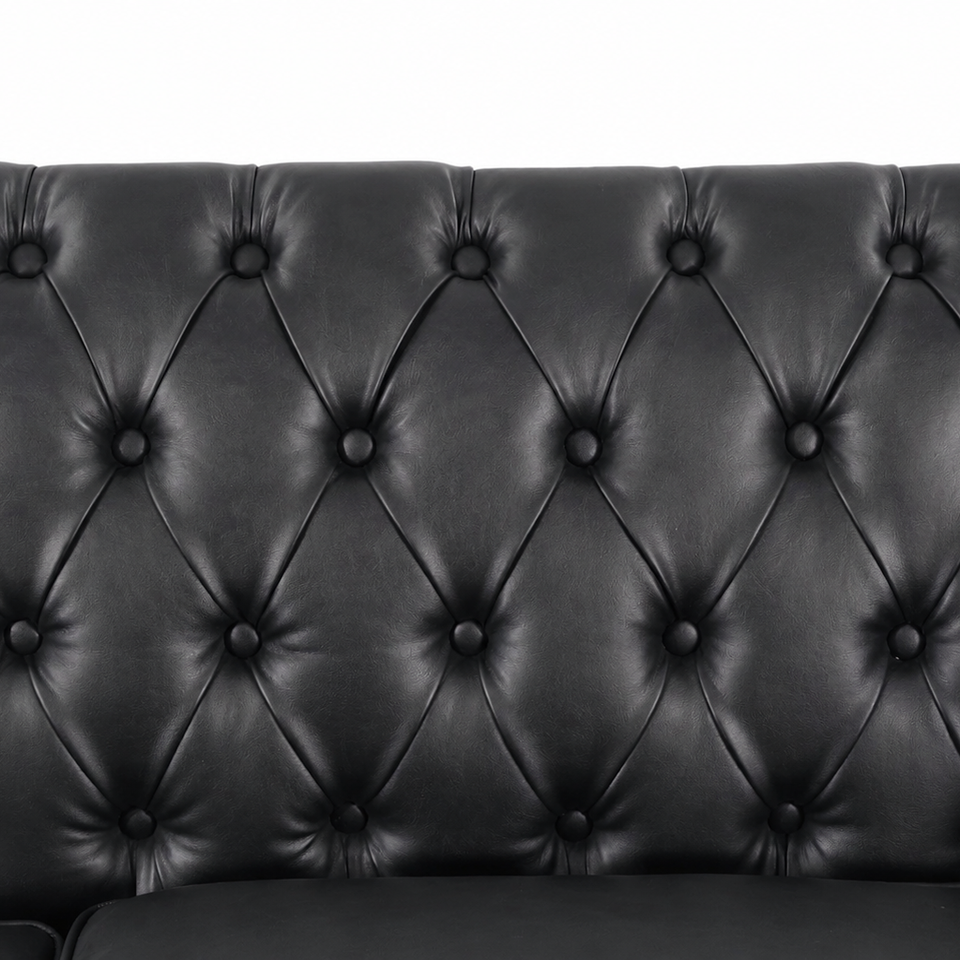 Close-up of a black tufted leather or faux-leather sofa backrest with diamond button tufting and a clean white background. black  3 Seater solo loveseat