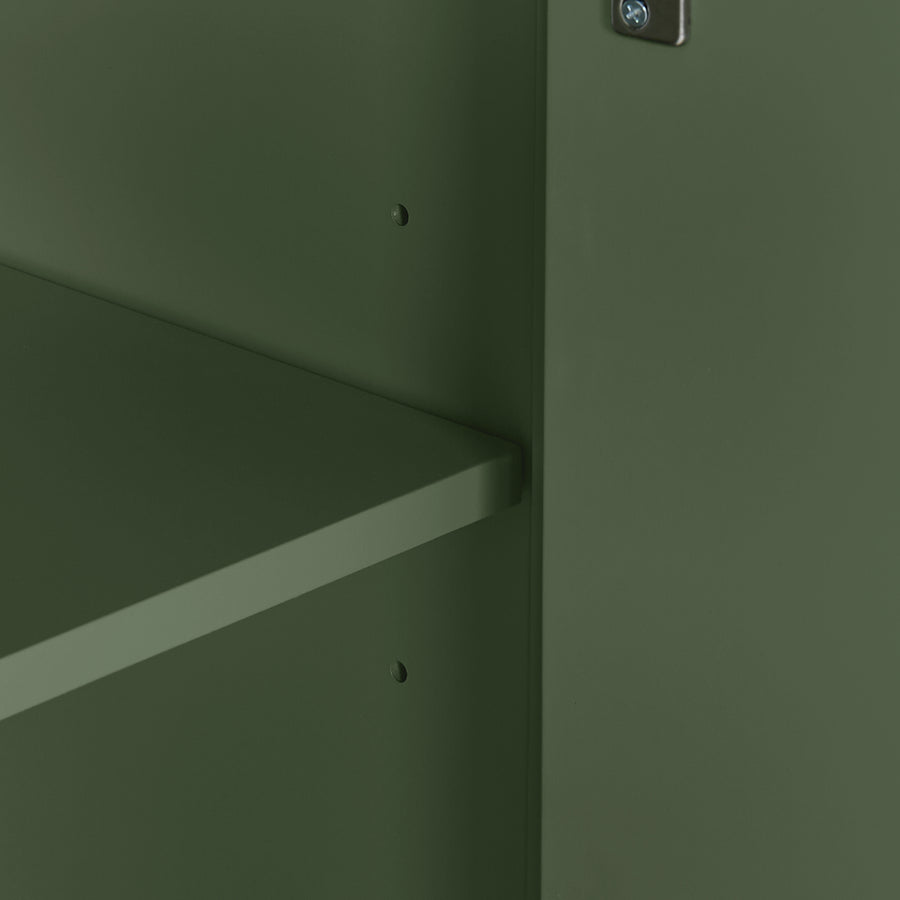 Close-up detail of a dark olive green metal cabinet or shelf unit, showing the corner where the door meets the shelf with small screw holes and a silver lock visible at the top.