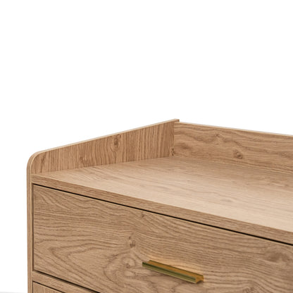 Close-up of a light natural  oak wood dresser or cabinet drawer with a curved front and a slim brass pull handle, set against a plain background.