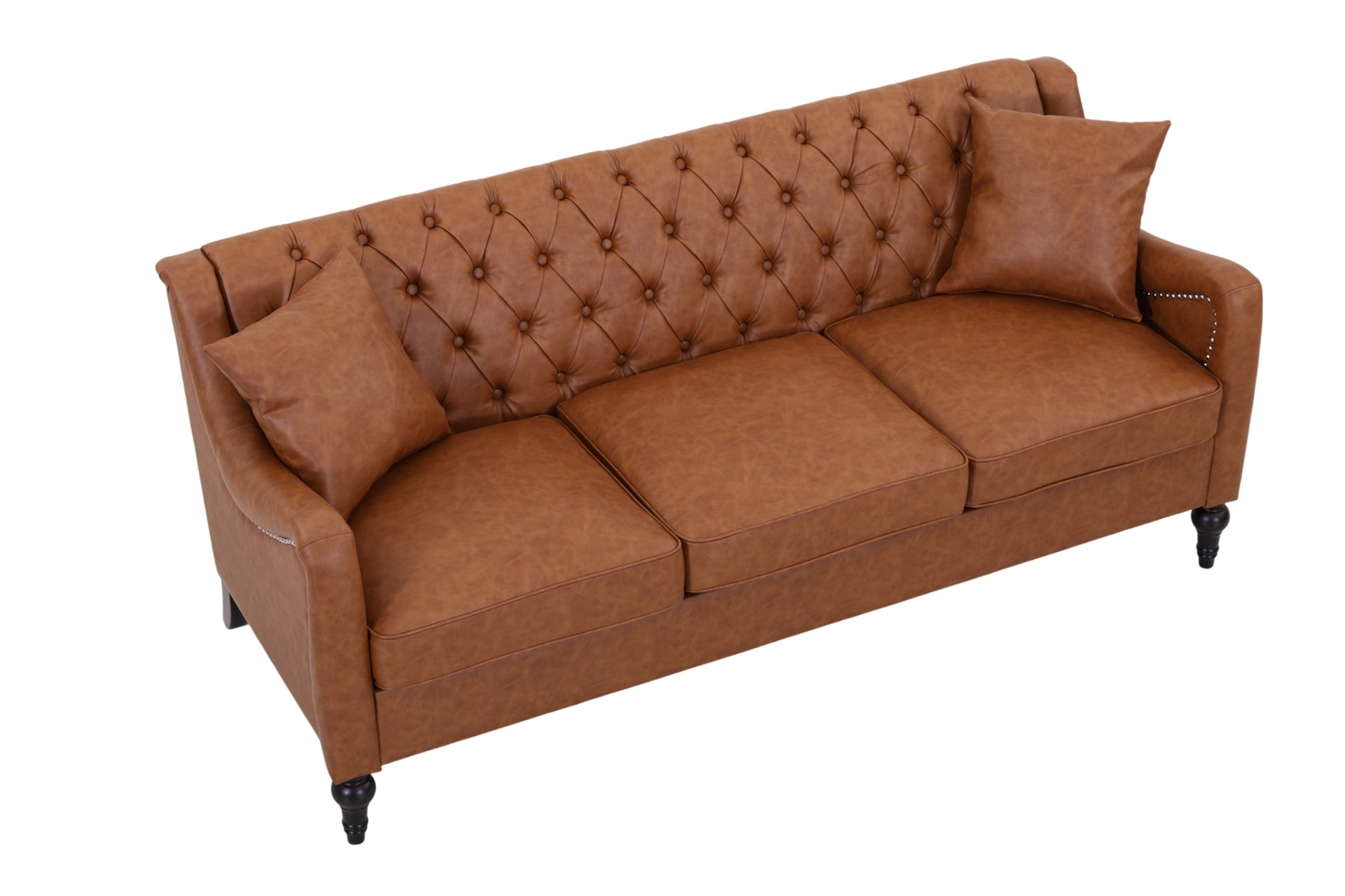 A brown faux leather three-seater sofa with a tufted diamond pattern on the backrest, two matching throw pillows, and dark turned legs, shown on a solid white background.  light brown 3 seater