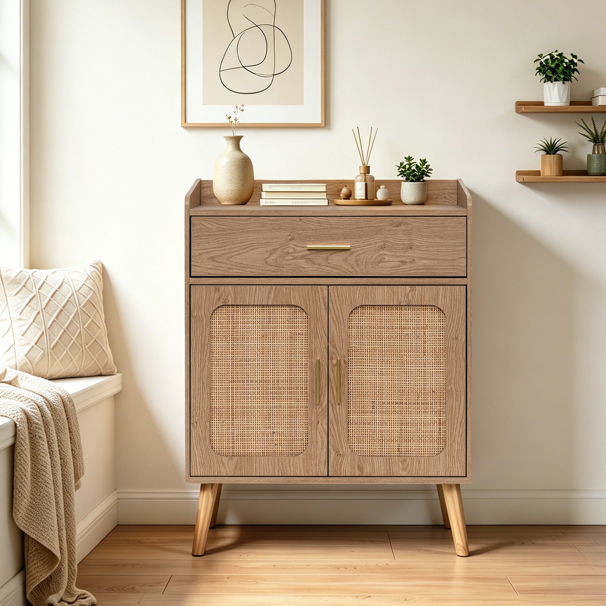 A mid-century modern natural wooden cabinet with a single drawer and two cane-embossed doors, styled in a bright, warm room with a bench, wall art, and small plants.