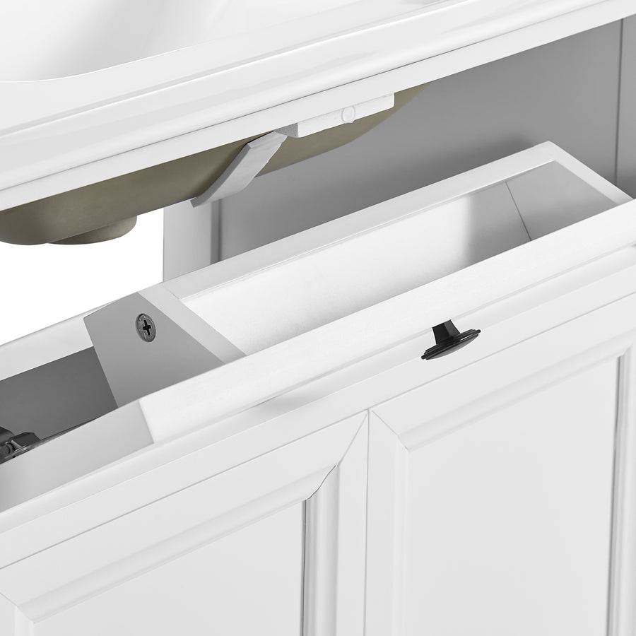 Close-up of a white bathroom vanity cabinet drawer with a black knob, showing the interior storage space and hardware.