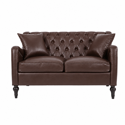 A classic Dark Brown Loveseat leather loveseat with a tufted button design on the backrest, two matching throw pillows, and dark turned wooden legs, shown against a plain white background.