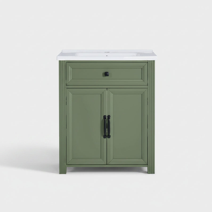 Olive green bathroom vanity cabinet with a ceramic sink basin, featuring a single drawer and two cabinet doors with black hardware, shown against a plain background.