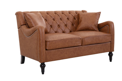 A brown faux leather loveseat sofa with a tufted button backrest, rolled arms with nailhead trim, and dark turned legs, shown on a white background. light brown loveseat