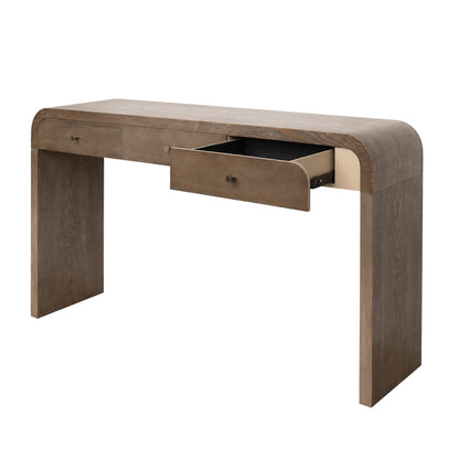 A modern wooden console desk with a curved top and legs, featuring a medium brown wood finish and an open drawer showing a black interior, set against a plain white background.