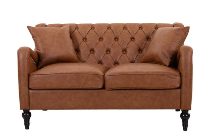 A brown leather loveseat sofa with a tufted button design on the backrest, two matching throw pillows, and dark turned wooden legs, shown against a plain white background. light brown loveseat