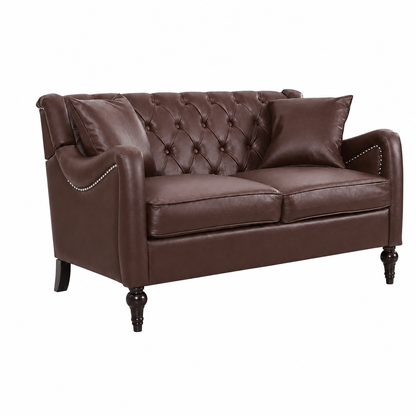 A dark brown faux leather loveseat sofa with a tufted button design on the backrest, two matching throw pillows, nailhead trim on the arms, and dark turned legs, shown on a plain white background. Dark Brown Loveseat 
