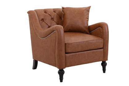A classic light brown solo faux leather armchair with button tufting on the backrest, a matching throw pillow, nailhead trim along the armrests, and dark turned wooden legs, shown against a plain white background.