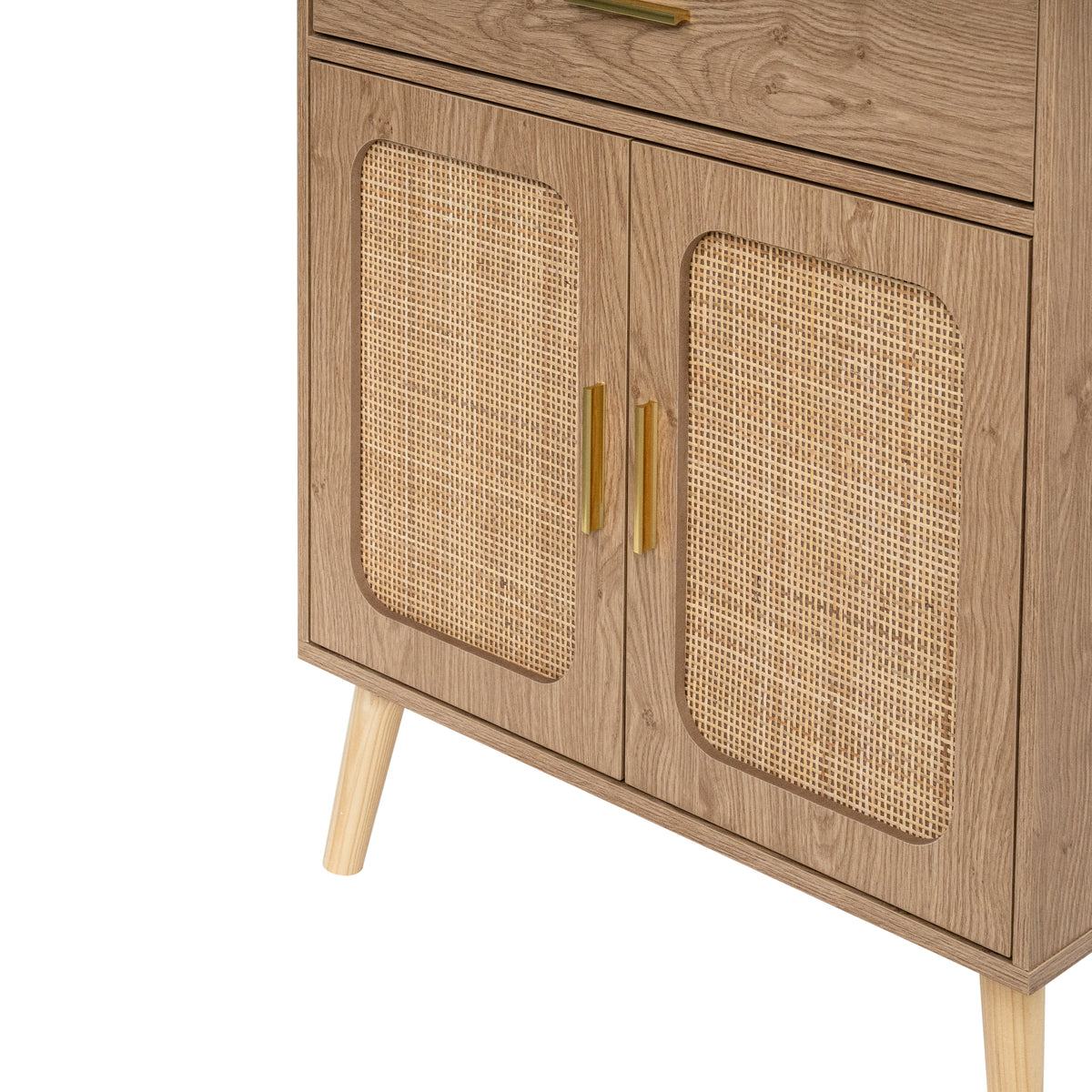 Close-up of a natural wooden cabinet with two doors featuring woven cane panels, gold-toned handles, and tapered wood legs on a background.